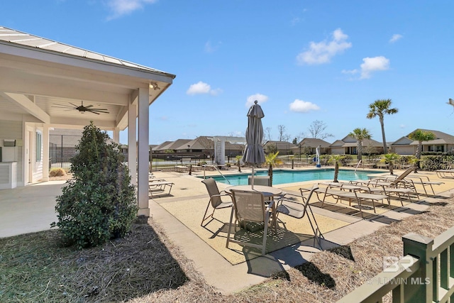 community pool with a patio area, fence, and a ceiling fan