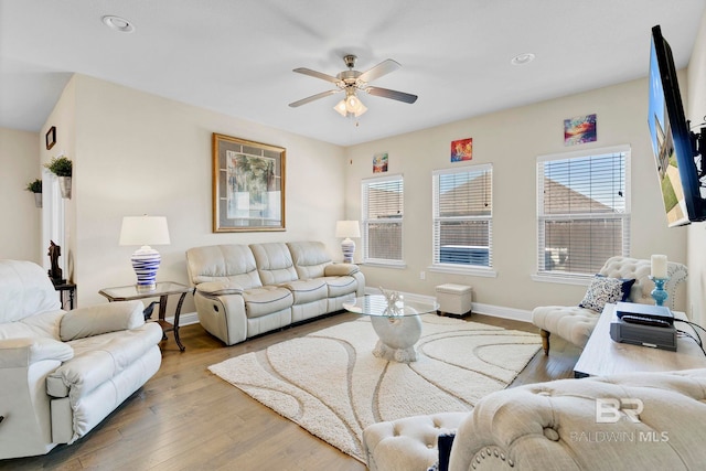 living area with a ceiling fan, baseboards, wood finished floors, and recessed lighting