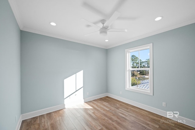 spare room with ceiling fan, ornamental molding, and light wood-type flooring