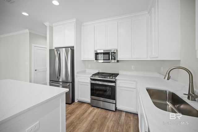 kitchen featuring white cabinetry, appliances with stainless steel finishes, and sink