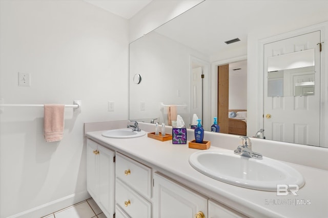 full bath featuring tile patterned floors, double vanity, a sink, and ensuite bathroom