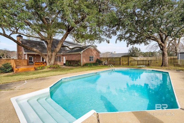 view of pool featuring a fenced in pool, a wooden deck, and a fenced backyard