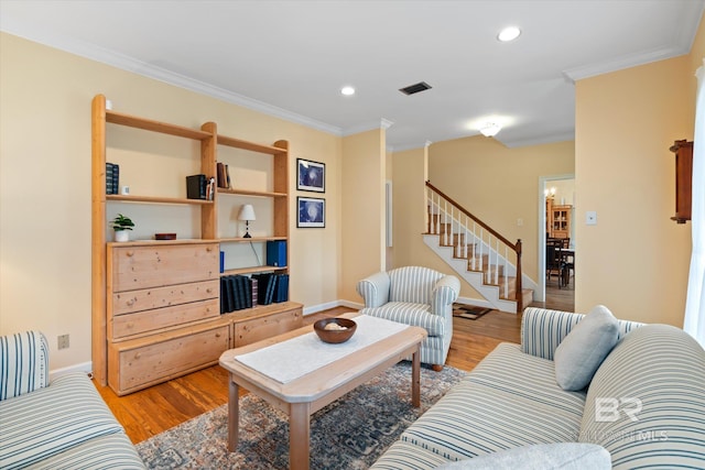 living room featuring light wood-style flooring, recessed lighting, stairs, and crown molding