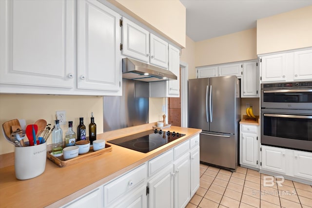 kitchen featuring under cabinet range hood, appliances with stainless steel finishes, light countertops, white cabinetry, and light tile patterned flooring