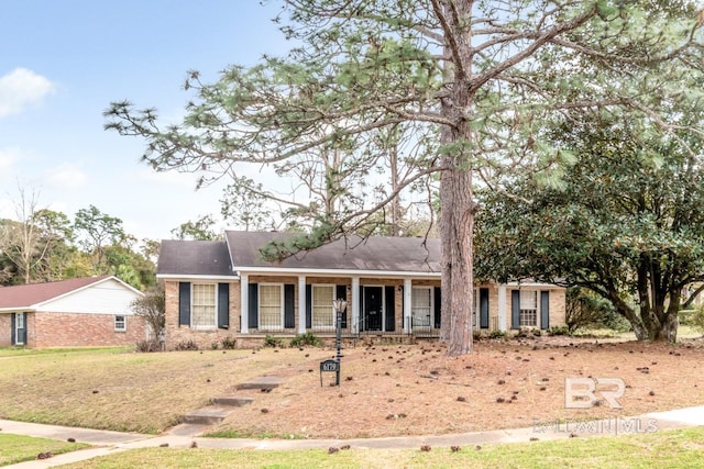 ranch-style home featuring brick siding and a porch