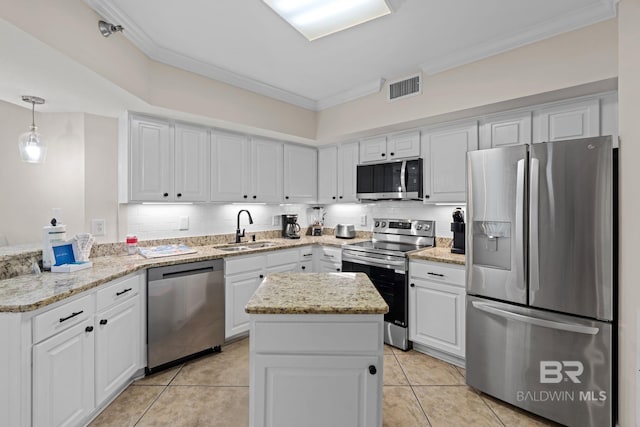 kitchen featuring white cabinetry, ornamental molding, stainless steel appliances, and a sink