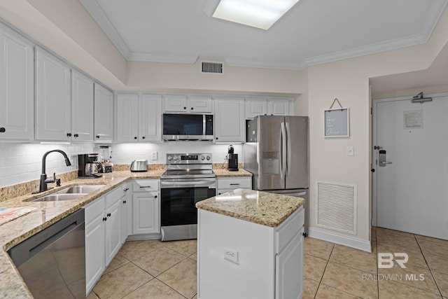 kitchen featuring white cabinets, visible vents, a sink, crown molding, and appliances with stainless steel finishes