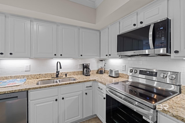 kitchen with white cabinets, stainless steel appliances, and a sink