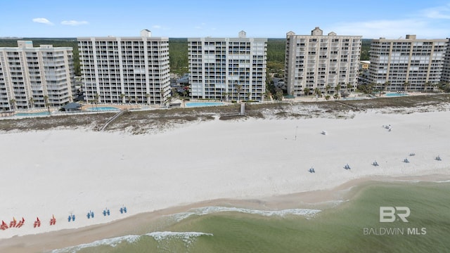 drone / aerial view with a beach view and a water view
