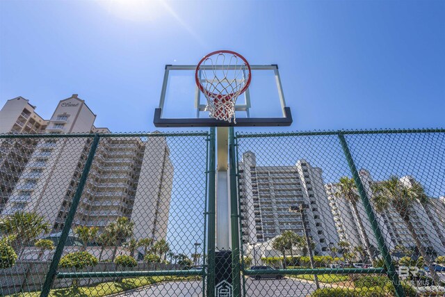 view of basketball court featuring fence