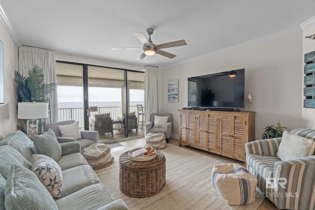 living room with ceiling fan, baseboards, and crown molding