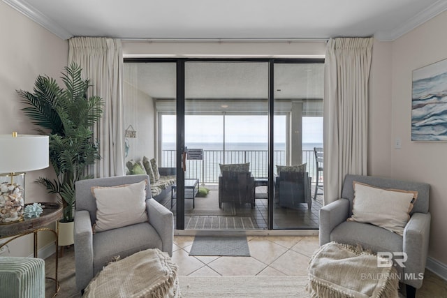 living area with tile patterned floors, a water view, and ornamental molding