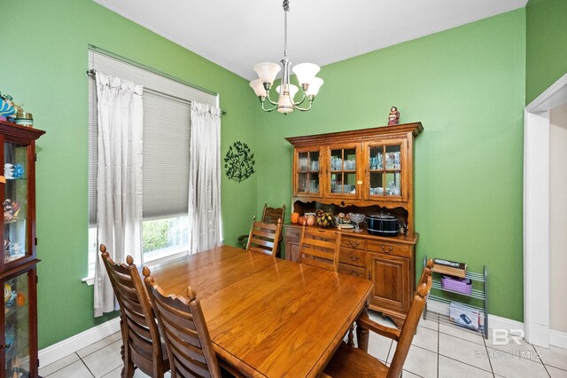 tiled dining area with an inviting chandelier