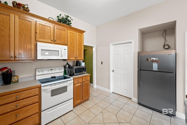 kitchen with light tile patterned flooring and stainless steel appliances