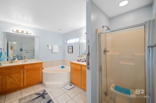 bathroom with tile patterned flooring, vanity, and shower with separate bathtub