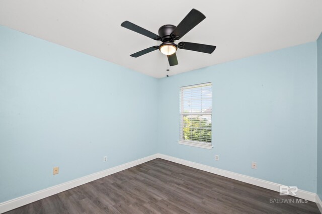 spare room featuring ceiling fan and dark wood-type flooring