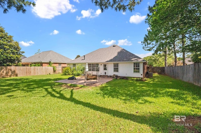 rear view of house featuring a lawn and a patio area