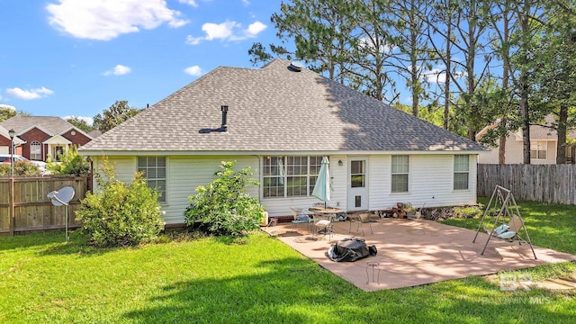 back of property featuring a lawn and a patio