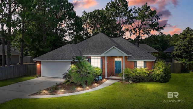 view of front facade with a lawn and a garage