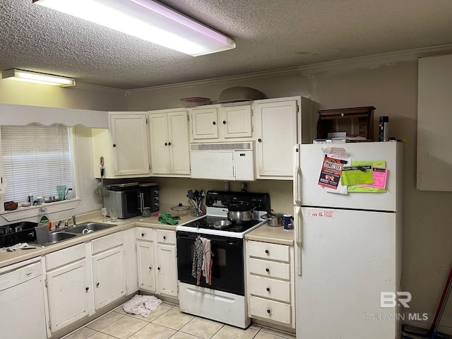 kitchen with white appliances, a textured ceiling, white cabinets, ornamental molding, and light tile patterned floors