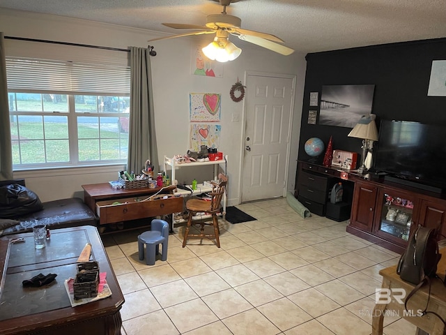 living room featuring a textured ceiling, ceiling fan, and light tile patterned floors