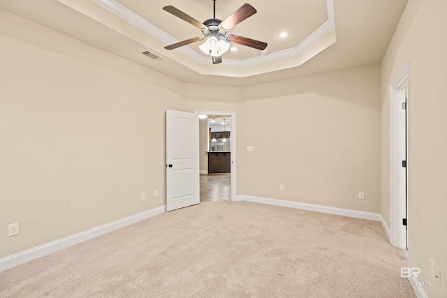 1077 Crown Walk Dr, Foley, AL 36535 - unfurnished room featuring a tray ceiling, a ceiling fan, baseboards, light colored carpet, and ornamental molding