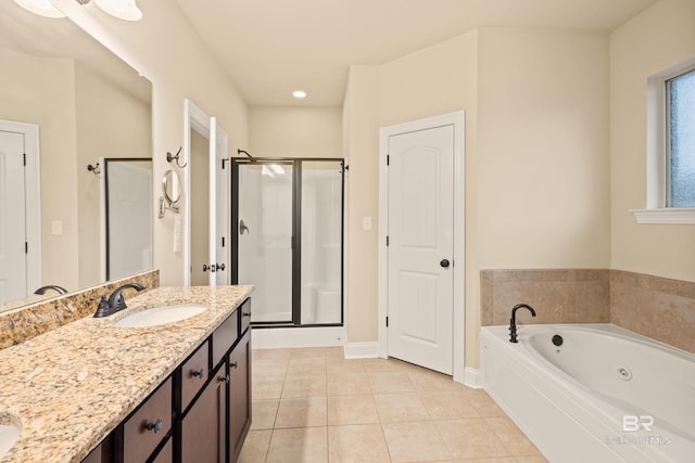 1077 Crown Walk Dr, Foley, AL 36535 - full bath with tile patterned flooring, vanity, baseboards, a shower stall, and a jetted tub