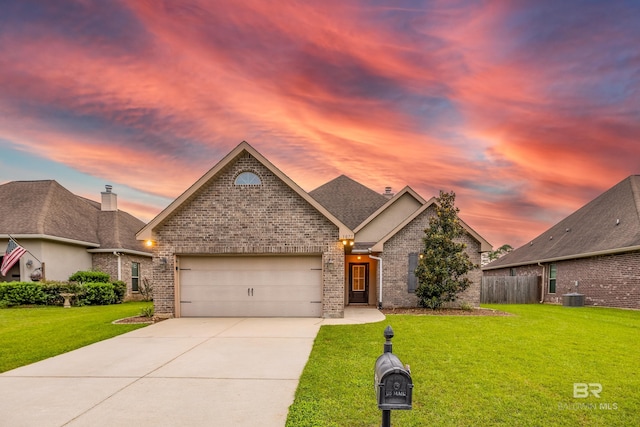 1077 Crown Walk Dr, Foley, AL 36535 - view of front of house featuring driveway, fence, brick siding, a lawn, and a garage
