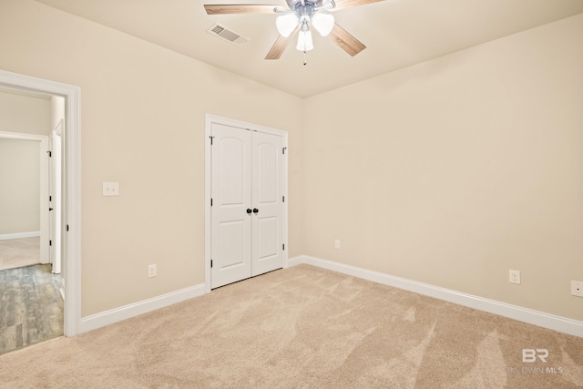 1077 Crown Walk Dr, Foley, AL 36535 - unfurnished bedroom with light colored carpet, baseboards, visible vents, a ceiling fan, and a closet