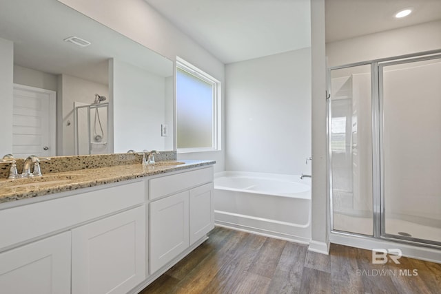 23159 Shadowridge Dr, Daphne, AL 36526 - bathroom with a stall shower, wood finished floors, a garden tub, and double vanity