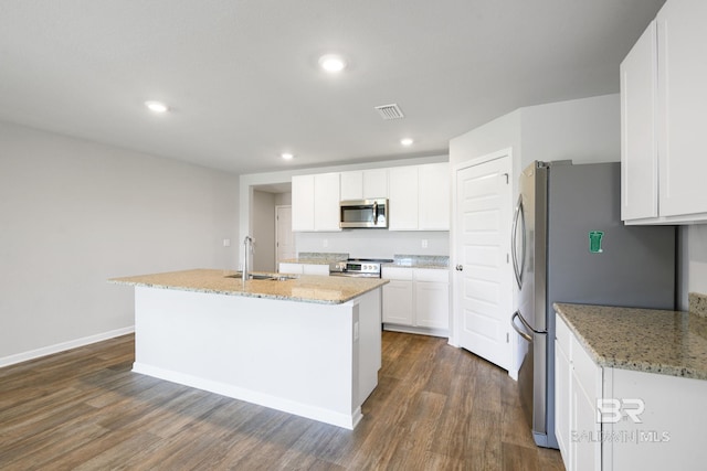 23159 Shadowridge Dr, Daphne, AL 36526 - kitchen featuring appliances with stainless steel finishes, dark wood-type flooring, white cabinetry, a kitchen island with sink, and light stone countertops