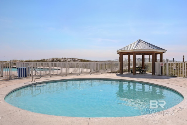 view of swimming pool with a gazebo and a patio area