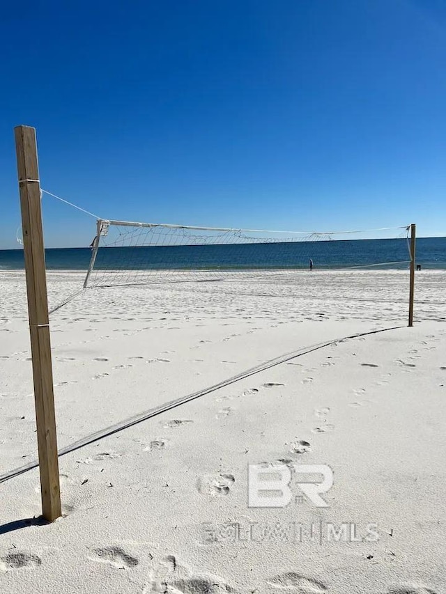 surrounding community with a water view and a view of the beach