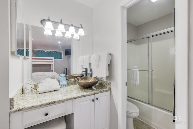 full bathroom featuring vanity, toilet, and enclosed tub / shower combo