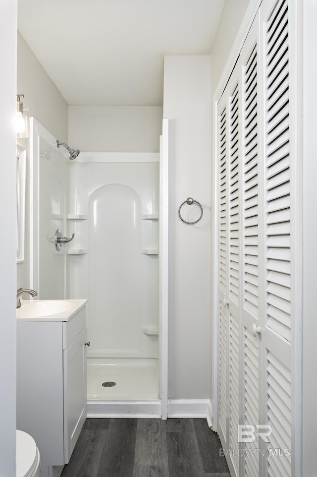 5922 Sunnyside Dr, Mobile, AL 36619 - bathroom featuring a shower stall, wood finished floors, vanity, and toilet