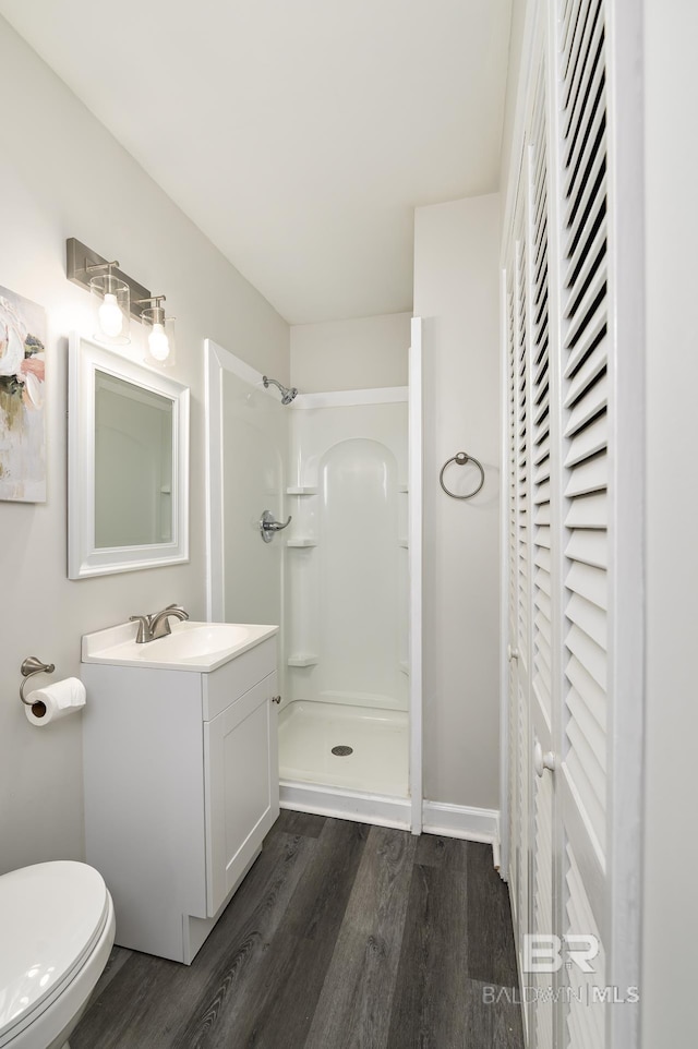 5922 Sunnyside Dr, Mobile, AL 36619 - full bathroom featuring a stall shower, wood finished floors, vanity, and toilet