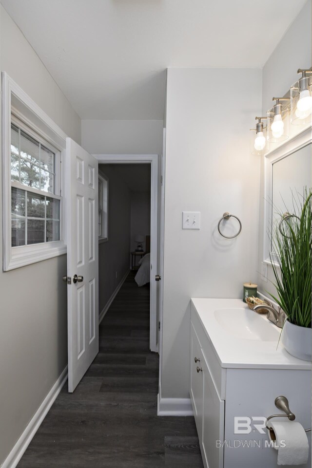 5922 Sunnyside Dr, Mobile, AL 36619 - bathroom with baseboards, vanity, and wood finished floors