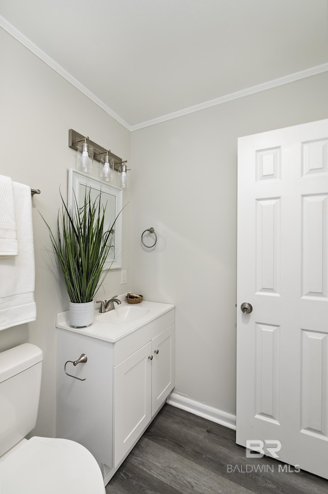 5922 Sunnyside Dr, Mobile, AL 36619 - half bathroom with crown molding, toilet, vanity, wood finished floors, and baseboards