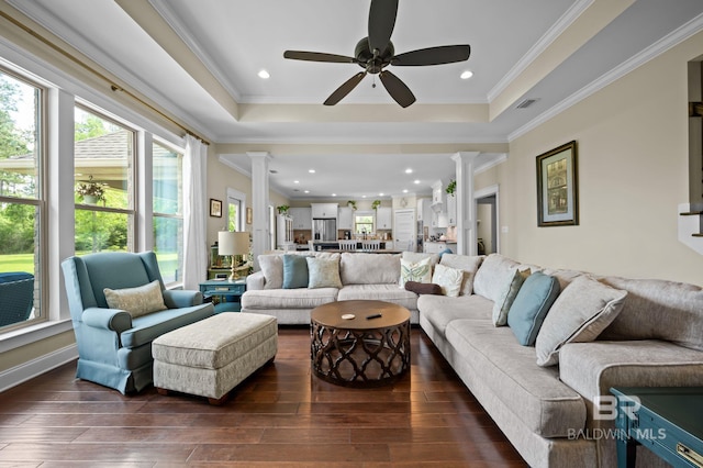 32035 Bobwhite Rd, Spanish Fort, AL 36527 - living room featuring ornate columns, hardwood / wood-style flooring, ceiling fan, a raised ceiling, and crown molding