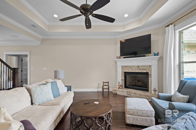 32035 Bobwhite Rd, Spanish Fort, AL 36527 - living room featuring a tray ceiling, wood finished floors, ceiling fan, crown molding, and stairway