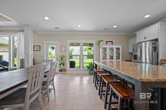 32035 Bobwhite Rd, Spanish Fort, AL 36527 - kitchen featuring stainless steel refrigerator with ice dispenser, plenty of natural light, light stone countertops, recessed lighting, and a breakfast bar