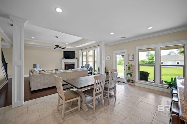 32035 Bobwhite Rd, Spanish Fort, AL 36527 - dining room featuring ornate columns, a fireplace, a ceiling fan, ornamental molding, and recessed lighting