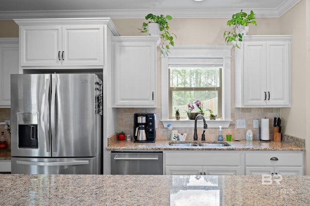 32035 Bobwhite Rd, Spanish Fort, AL 36527 - kitchen with stainless steel appliances, a sink, white cabinets, backsplash, and crown molding