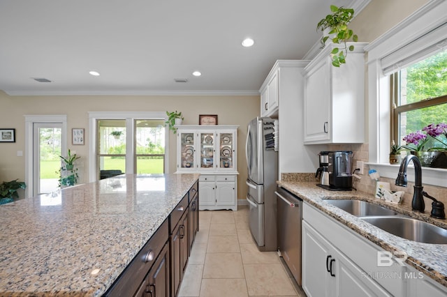 32035 Bobwhite Rd, Spanish Fort, AL 36527 - kitchen featuring a sink, appliances with stainless steel finishes, white cabinetry, light stone counters, and light tile patterned floors
