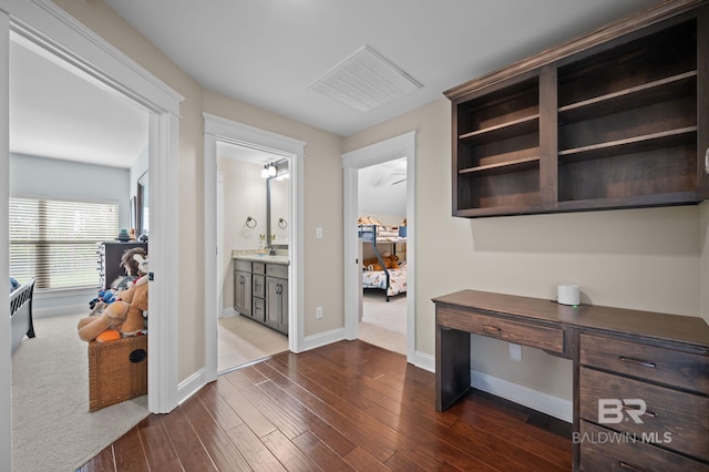 32035 Bobwhite Rd, Spanish Fort, AL 36527 - corridor featuring dark wood-style floors, baseboards, and a sink