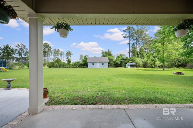 32035 Bobwhite Rd, Spanish Fort, AL 36527 - view of green lawn featuring an outdoor structure and a patio