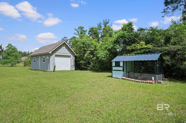 32035 Bobwhite Rd, Spanish Fort, AL 36527 - view of green lawn featuring an outbuilding, a detached garage, and exterior structure