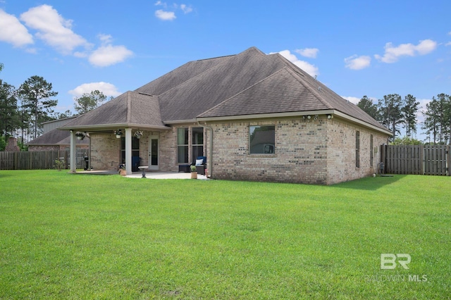 32035 Bobwhite Rd, Spanish Fort, AL 36527 - back of house featuring brick siding, a patio area, and roof with shingles