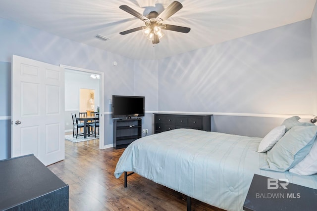 bedroom featuring ceiling fan and dark hardwood / wood-style flooring