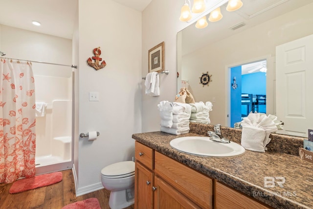 bathroom with vanity, toilet, hardwood / wood-style flooring, and a shower with shower curtain